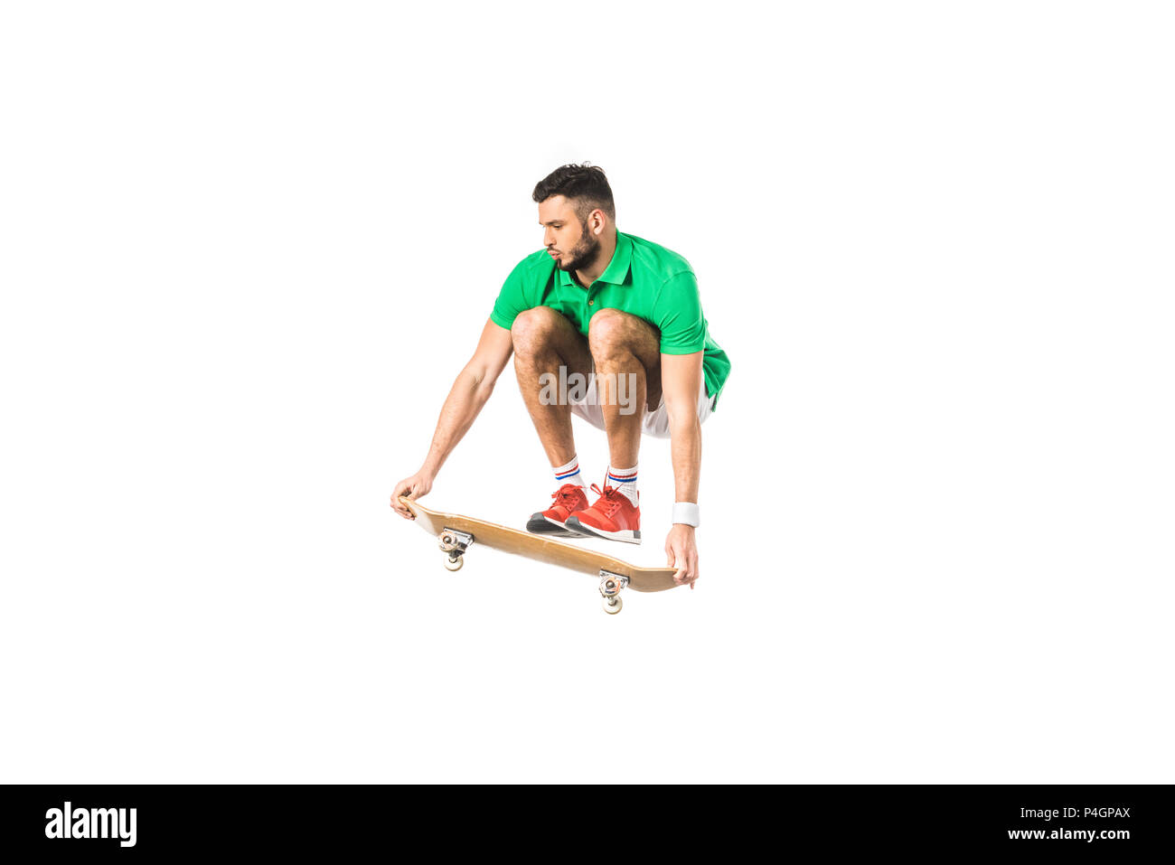 handsome young man jumping with skateboard isolated on white Stock Photo
