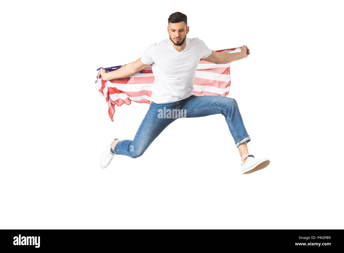 handsome young man holding american flag and jumping isolated on white ...