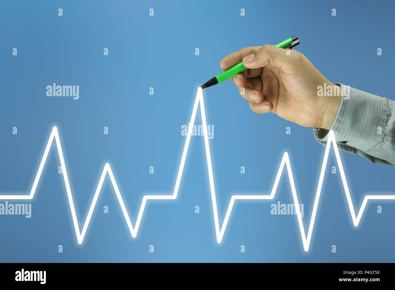 businessman hand with a pen pointing to the top line of a graph on blue ...