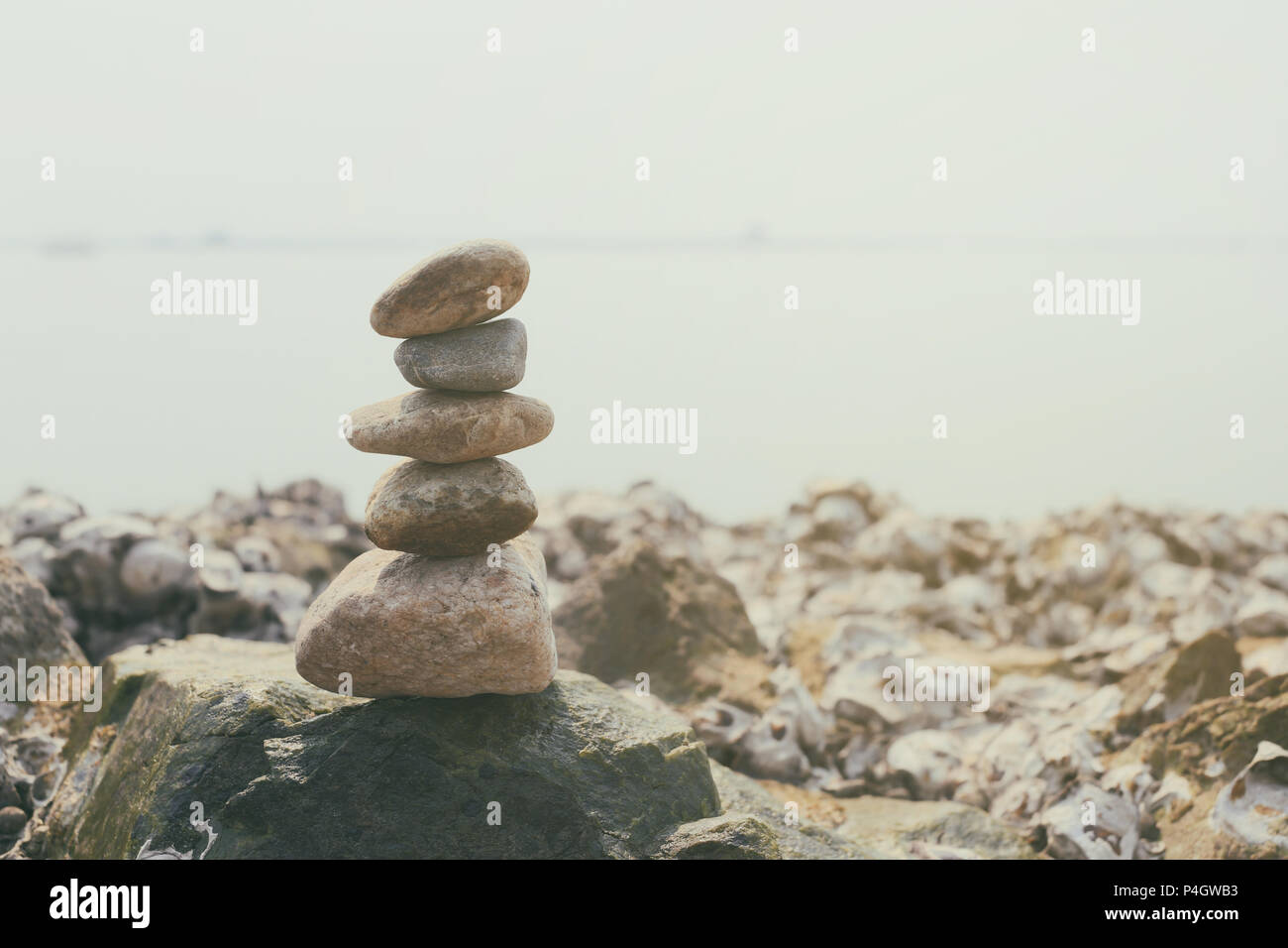 Stacked of stones on the summer coast in calmness and relaxation concept for design in your work. Stock Photo