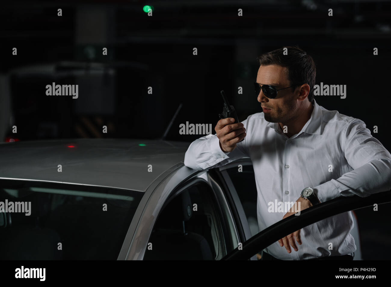 male undercover agent in sunglasses using talkie walkie near car Stock  Photo - Alamy