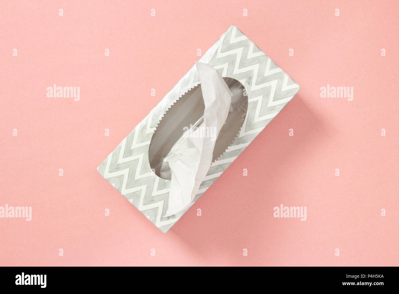 Gray tissue box on pastel pink background. Healthcare and hygiene. Stock Photo