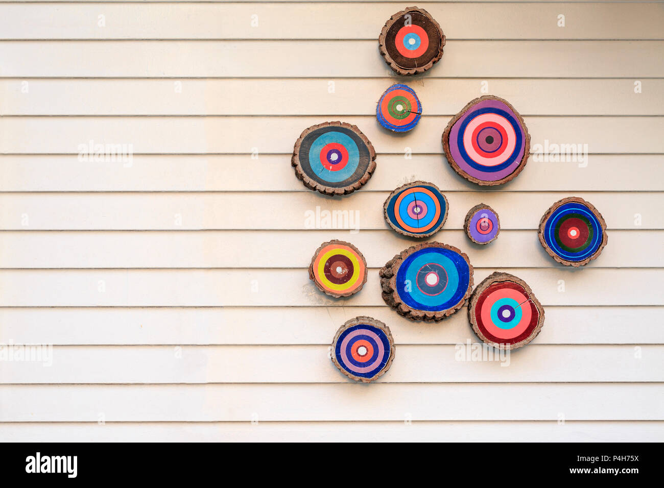 Colorful evil eyes (Nazar boncugu) on the cream wooden wall Stock Photo