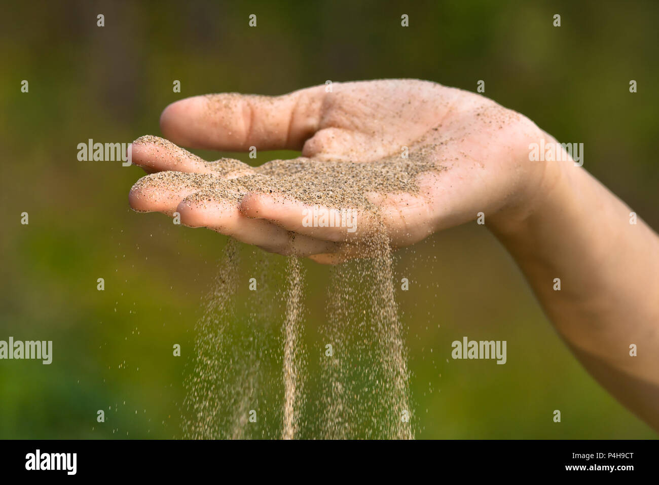 sand running through fingers like time running out Stock Photo