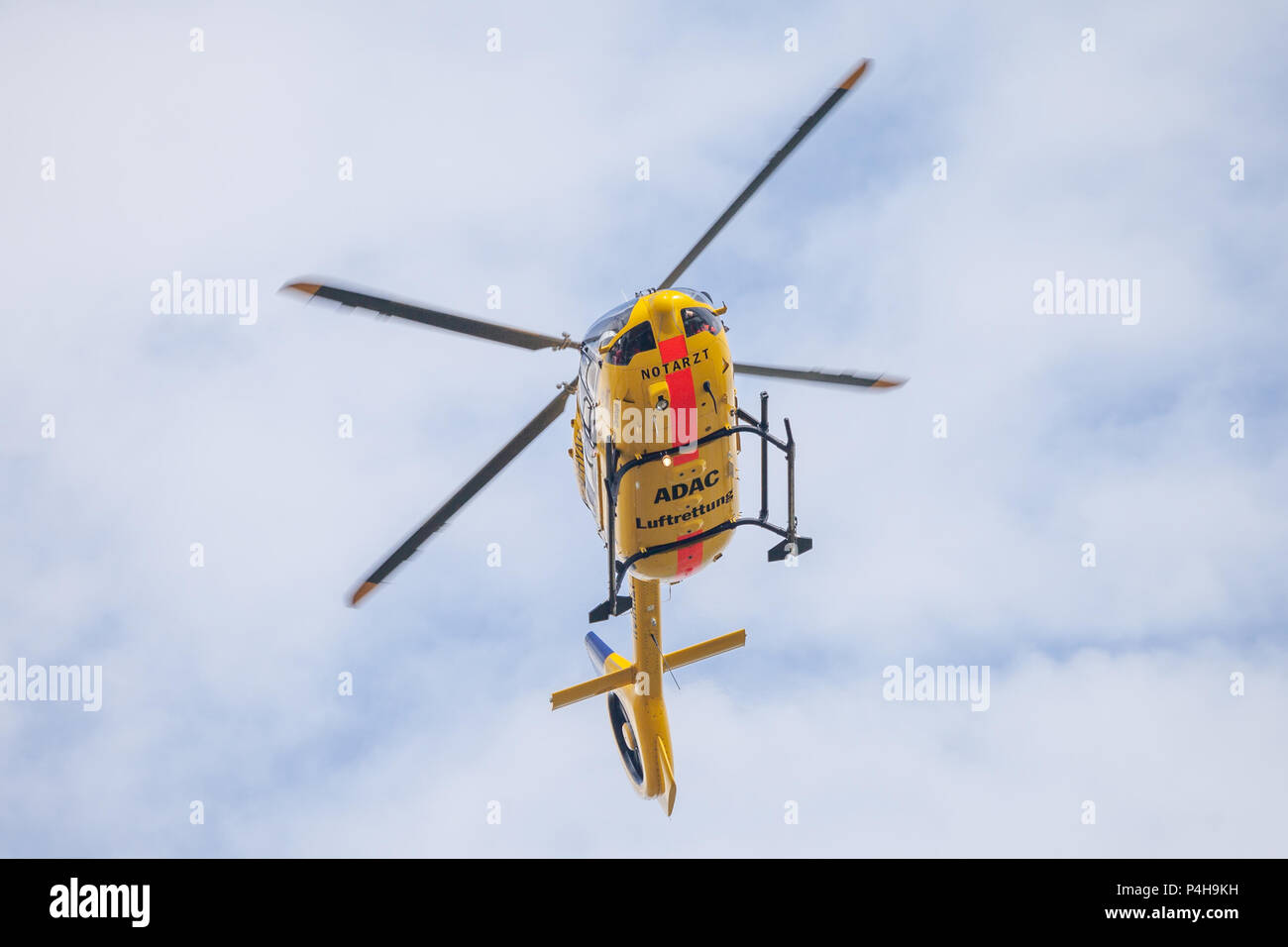 FELDKIRCHEN / GERMANY - JUNE 09, 2018: Eurocopter EC-135 from ADAC Luftrettung flies over landing side. Notarzt means emergency doctor. Stock Photo