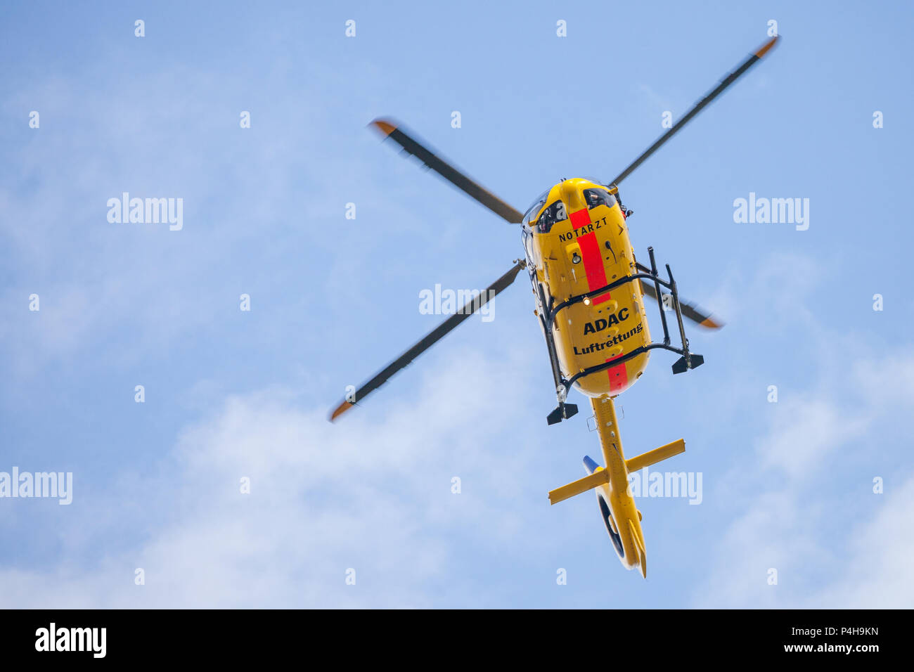 FELDKIRCHEN / GERMANY - JUNE 09, 2018: Eurocopter EC-135 from ADAC Luftrettung flies over landing side. Notarzt means emergency doctor. Stock Photo