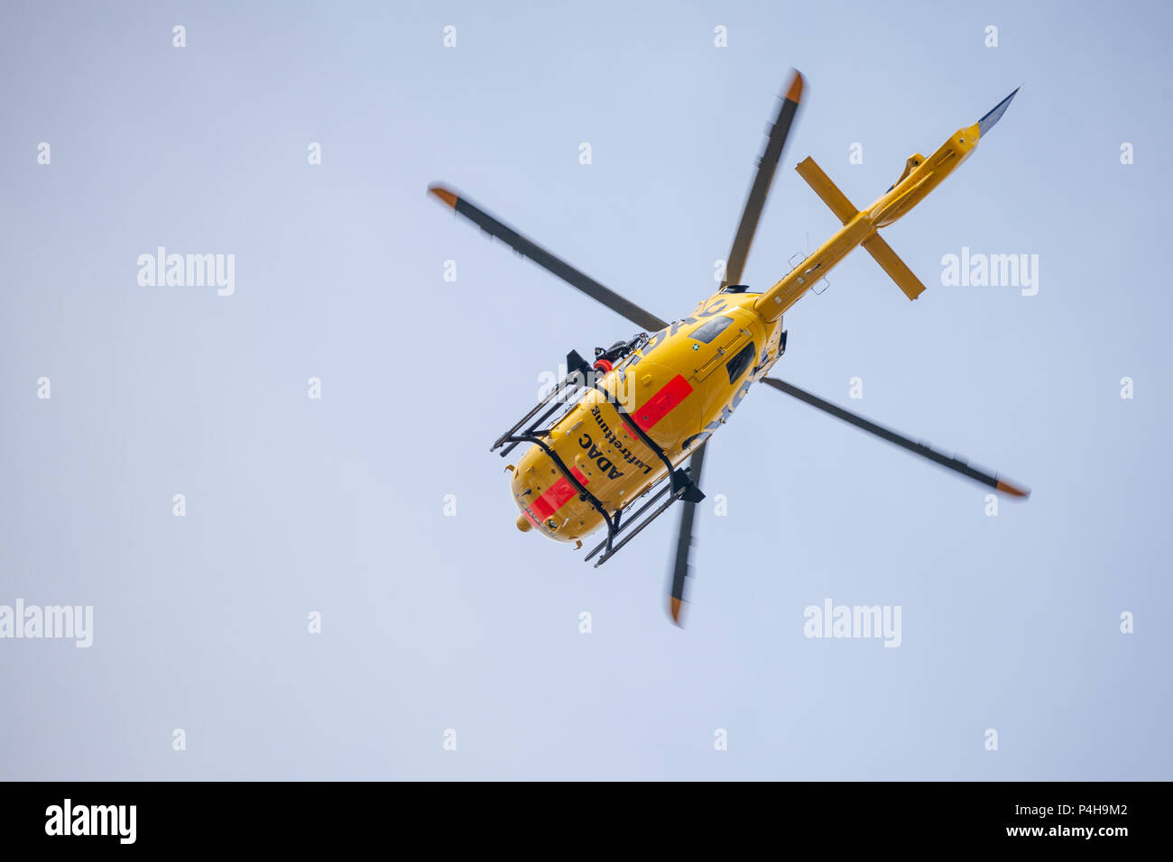 FELDKIRCHEN / GERMANY - JUNE 09, 2018: Eurocopter EC-135 from ADAC Luftrettung flies over landing side. Notarzt means emergency doctor. Stock Photo