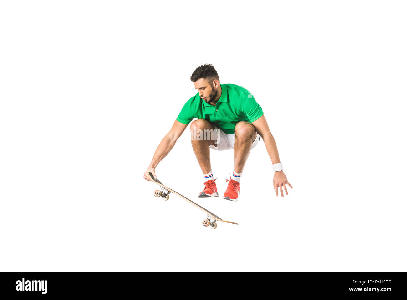 handsome young man jumping with longboard isolated on white Stock Photo
