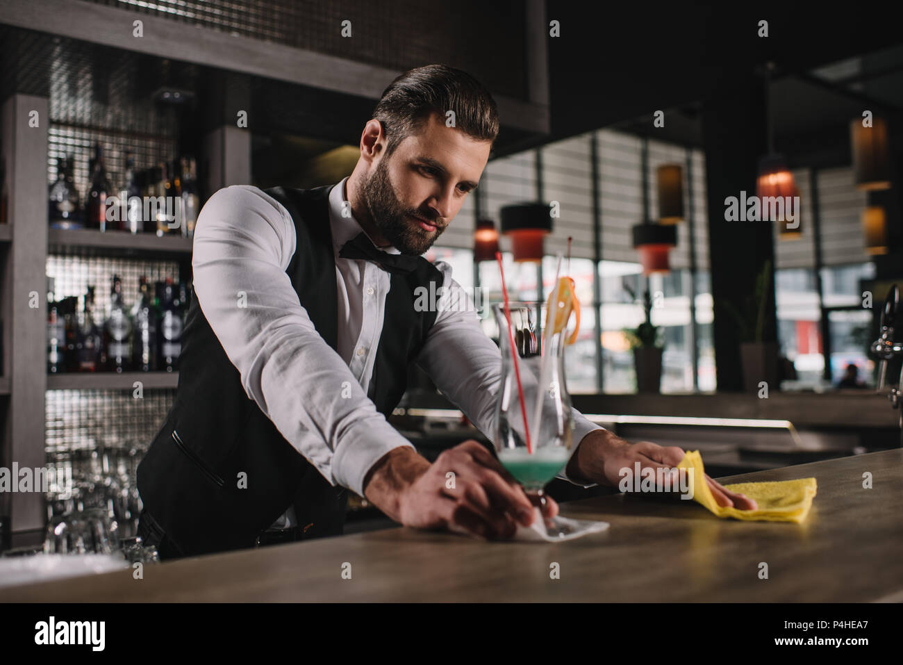 handsome bartender cleaning bar counter with rag Stock Photo Alamy