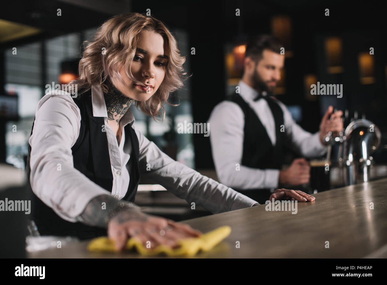 female bartender cleaning bar counter Stock Photo Alamy