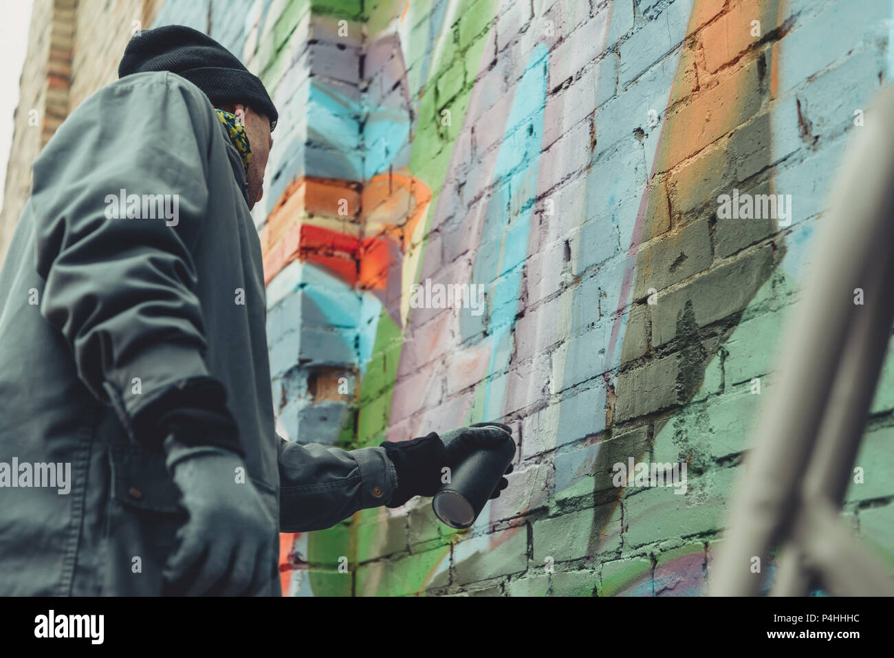 street artist painting colorful graffiti on wall Stock Photo - Alamy