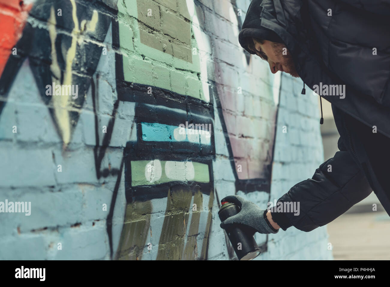 street artist painting colorful graffiti on wall Stock Photo - Alamy