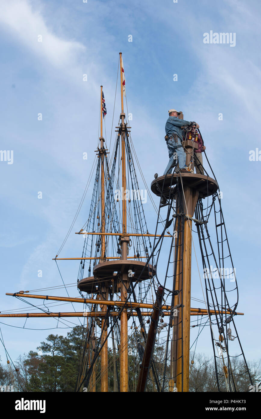 Rigging disassembly proceeds on historic sailing ship, a 17th century recreation, at Jamestown Settlement, historic Jamestown, as piece is lowered. Stock Photo