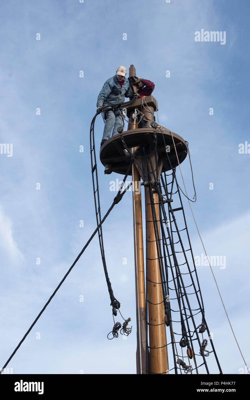 Rigging disassembly proceeds on historic sailing ship, a 17th century recreation, at Jamestown Settlement Pier, historic Jamestown, piece is lowered. Stock Photo