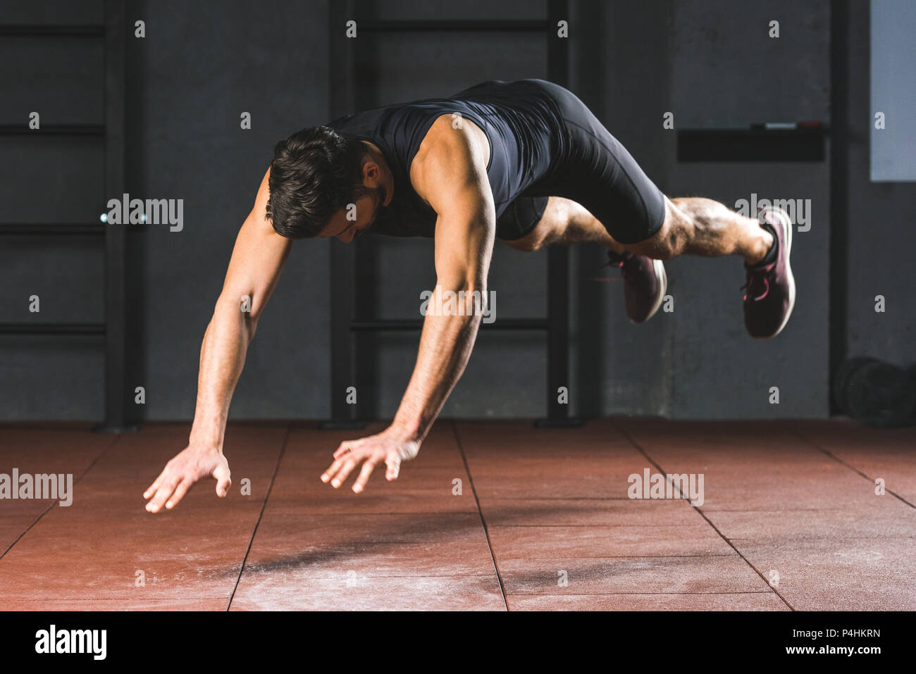 Young sportsman doing push ups in sports hall Stock Photo - Alamy