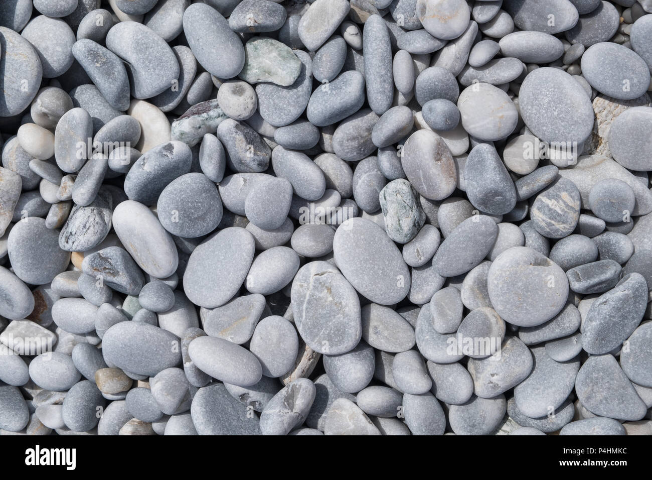 Background of pebbles on a beach. Stock Photo
