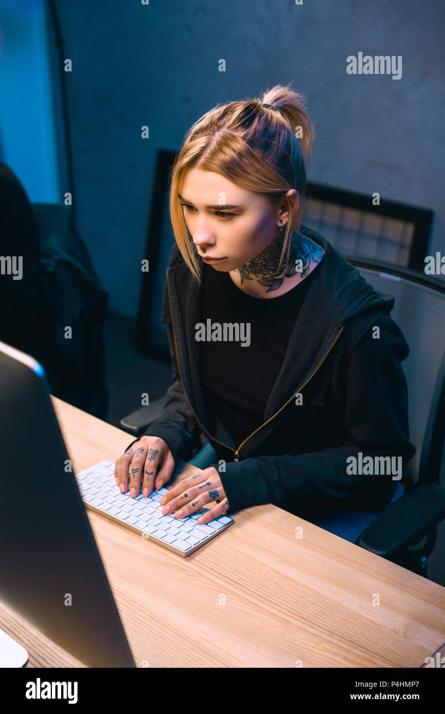 high angle view of serious young female hacker developing malware Stock Photo