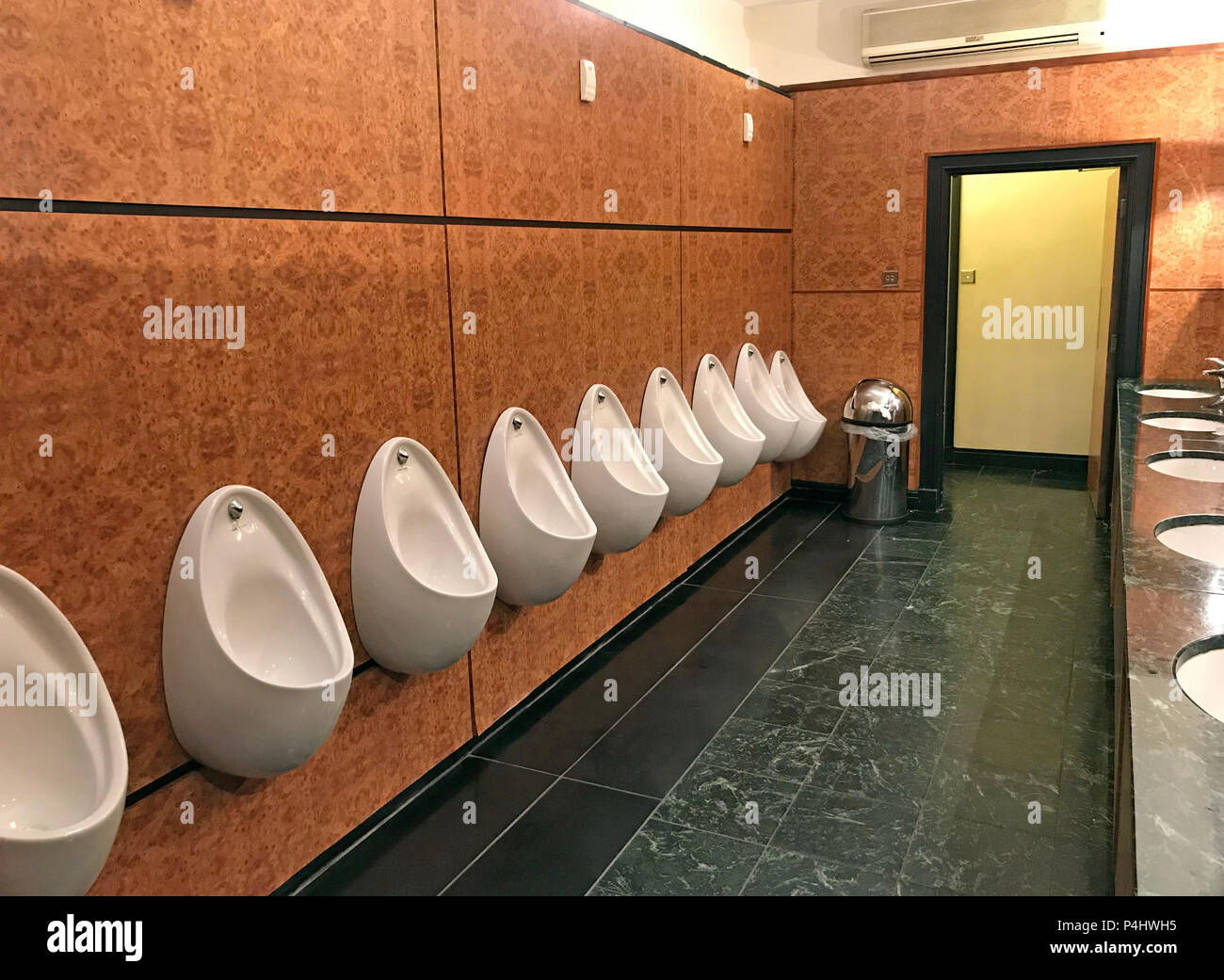 A line of Gents Urinals, in a large hotel, Leeds, West Yorkshire, England, UK Stock Photo