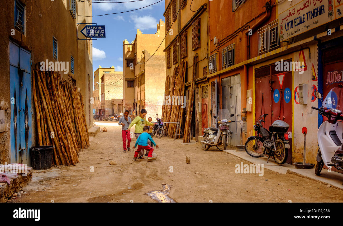 Children playing football in a street in Tinghir, Morocco Stock Photo