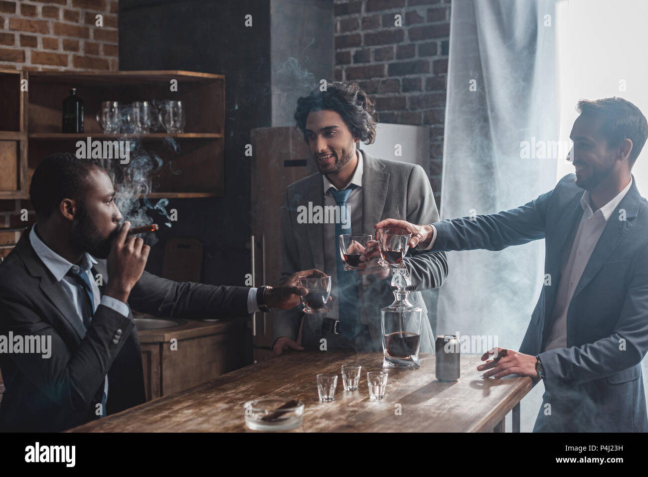 https://c8.alamy.com/comp/P4J23H/cheerful-male-friends-in-formal-wear-smoking-cigars-and-clinking-glasses-of-whiskey-P4J23H.jpg