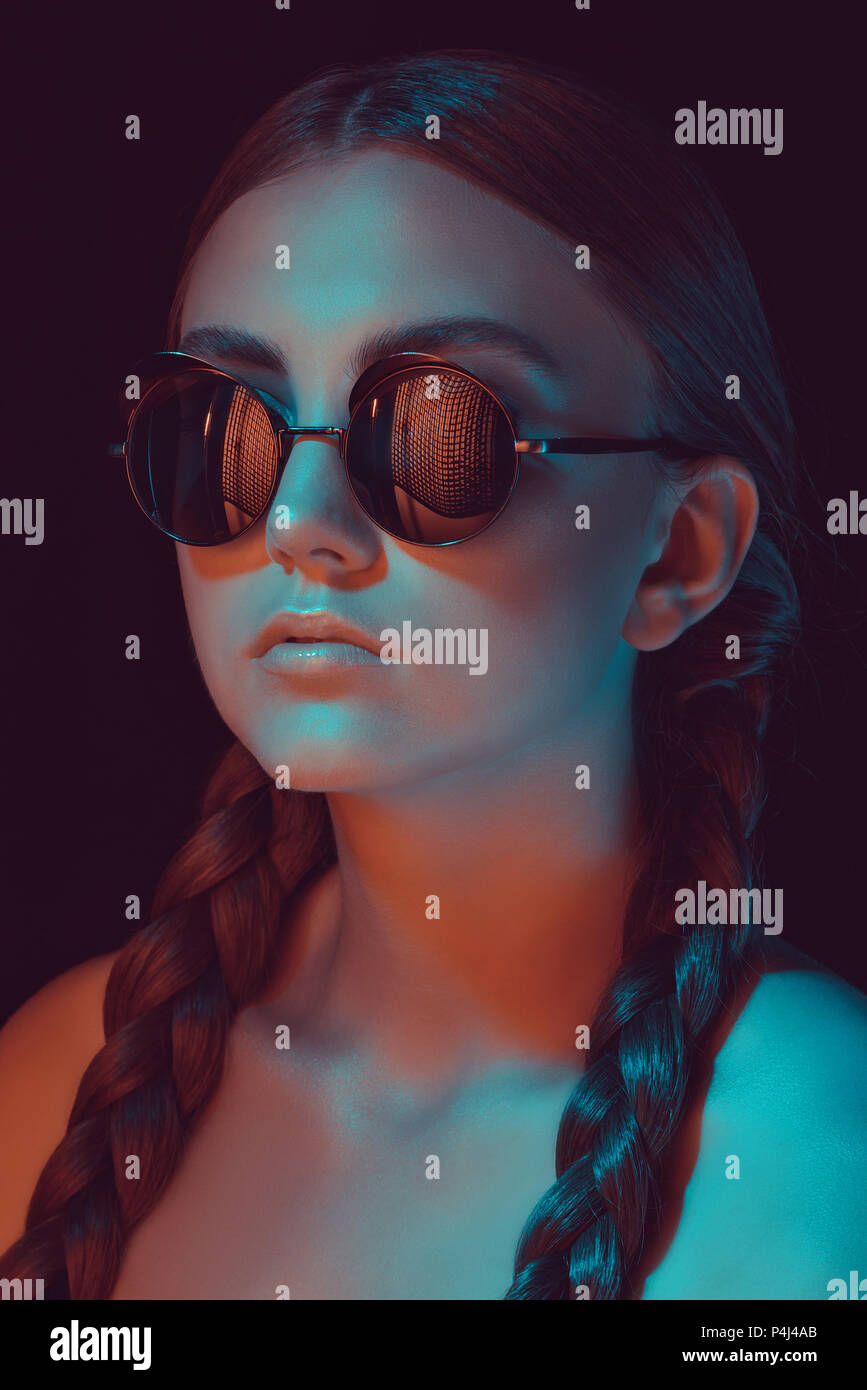portrait of caucasian young woman with braids in fashionable sunglasses Stock Photo