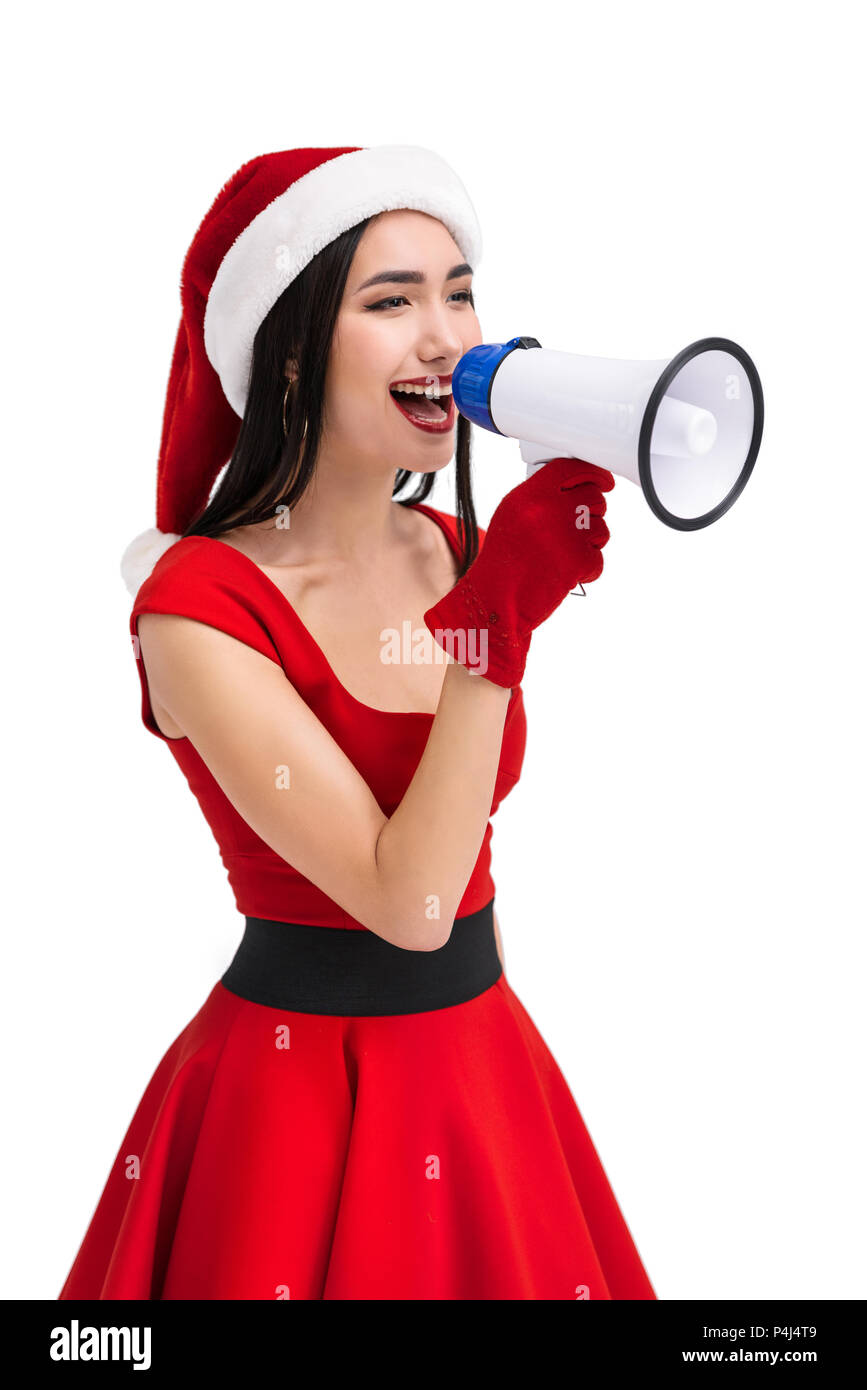 portrait of cheerful asian woman in santa claus costume with megaphone ...
