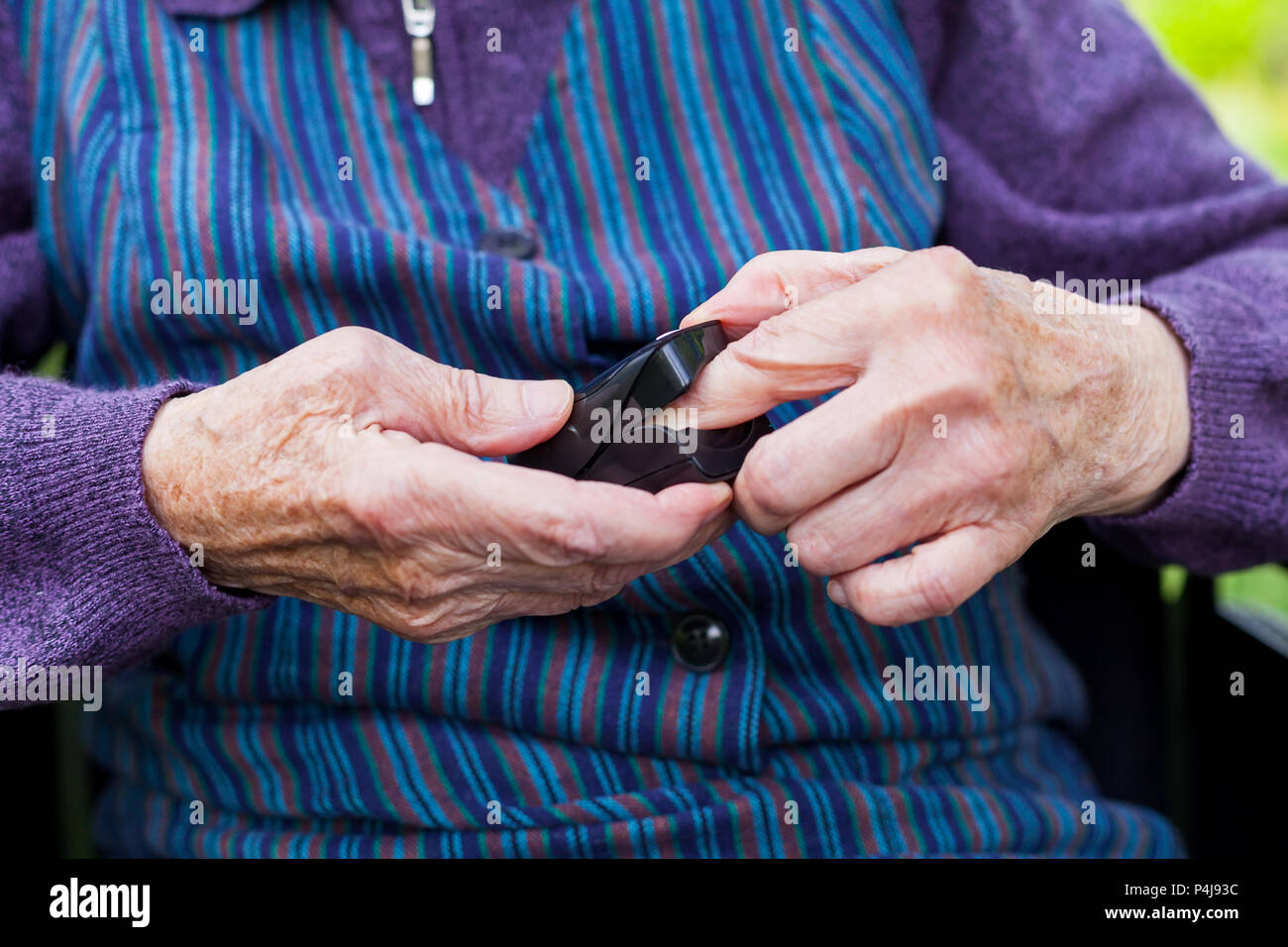 Close up picture of old woman's hands holding pulse oximeter on ...