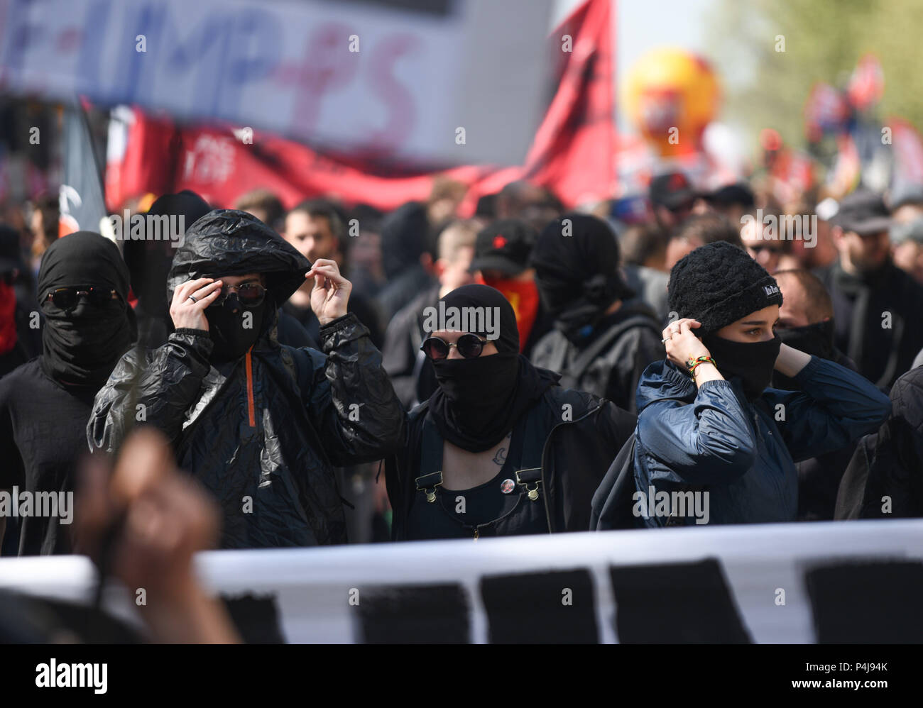 April 19, 2018 - Paris, France: Anti-capitalist anarchists cover their faces as they prepare to protest. Thousands of people including students, rail workers, and hospital workers demonstrated in Paris against president Emmanuel Macron's economic policies.  Des manifestants anarchistes, connus comme le black bloc, mettent leurs masques avant le debut d'une manifestation contre la casse des services publics. Stock Photo