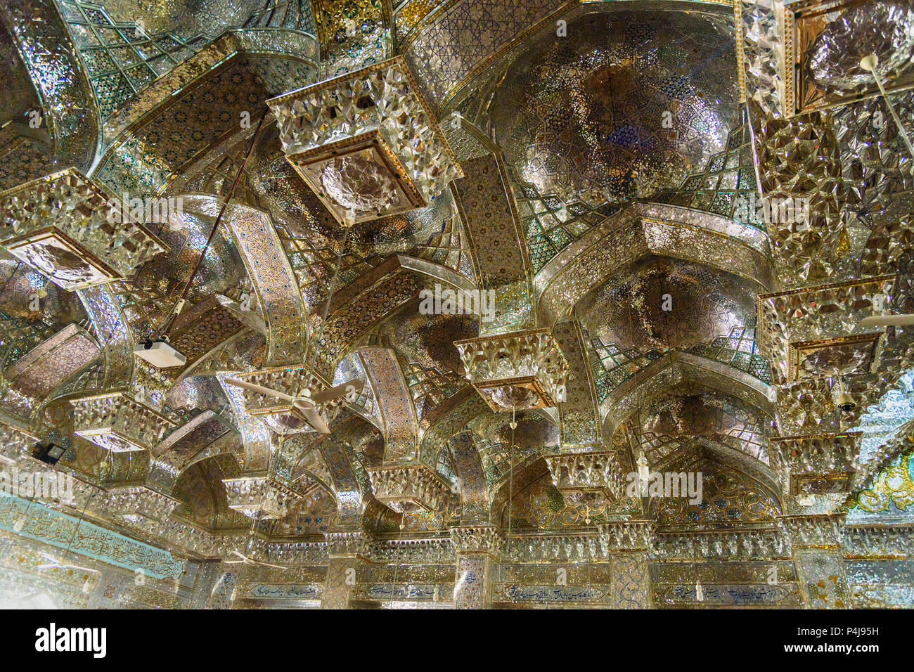 Shiraz, Iran - March 25, 2018: View on ceiling inside of mirrored mausoleum of Sayyed Alaeddin Hossein Stock Photo