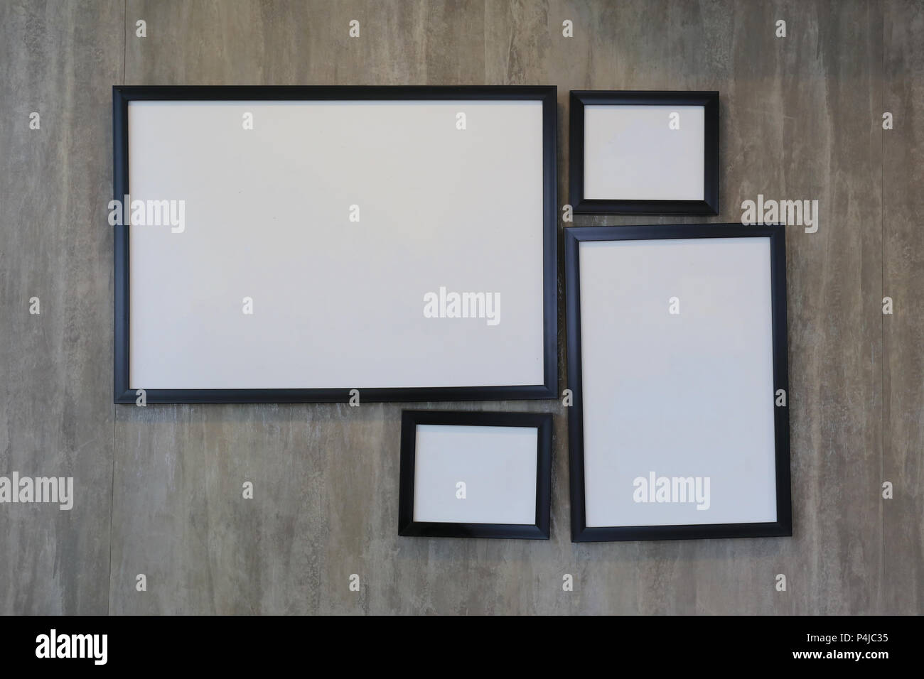 Empty vintage picture frame on concrete wall for the design in your work concept. Stock Photo