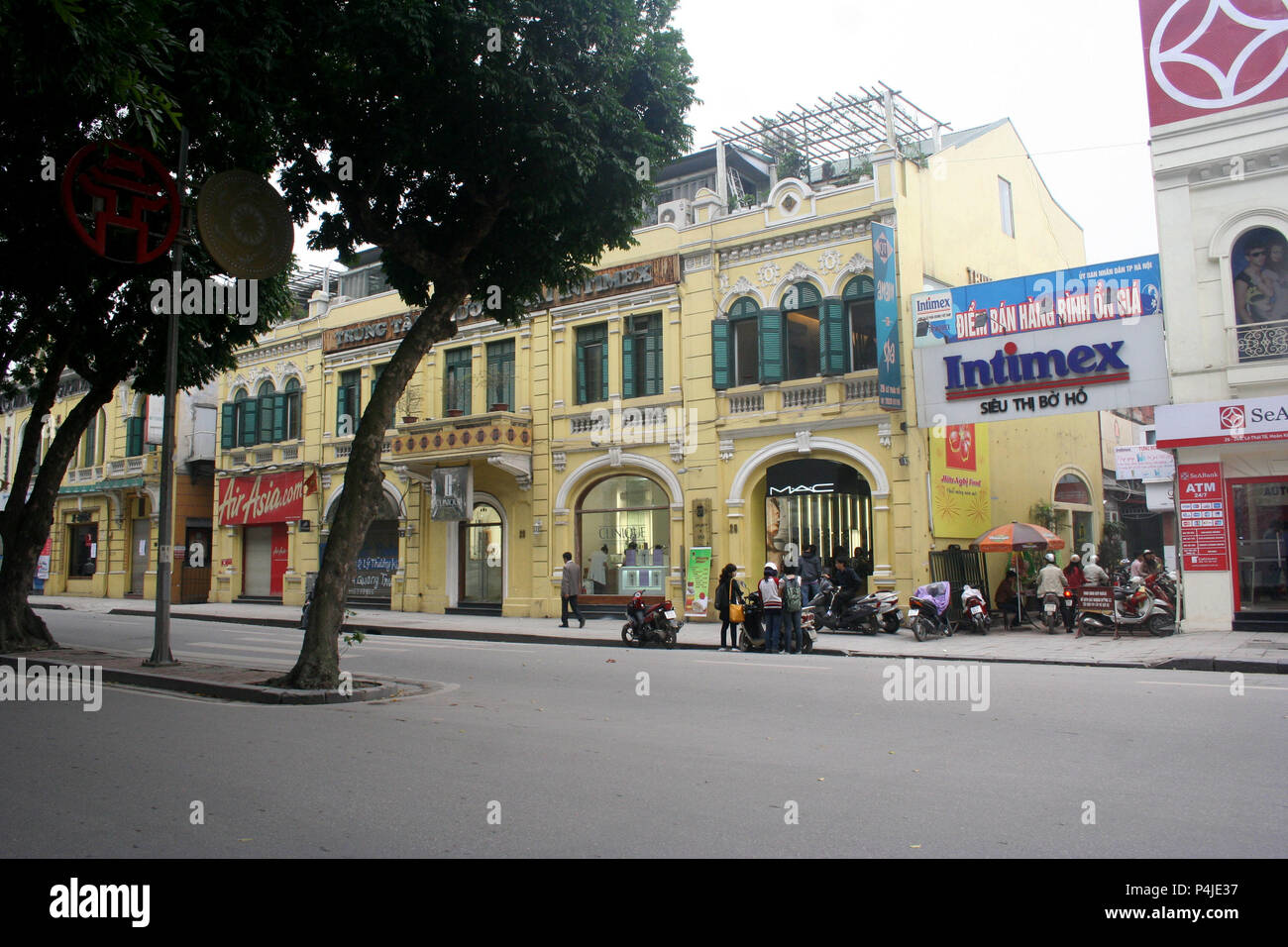 Row of Yellow Colonial Shopfronts with Green Shutters, Hanoi, Vietnam Stock Photo
