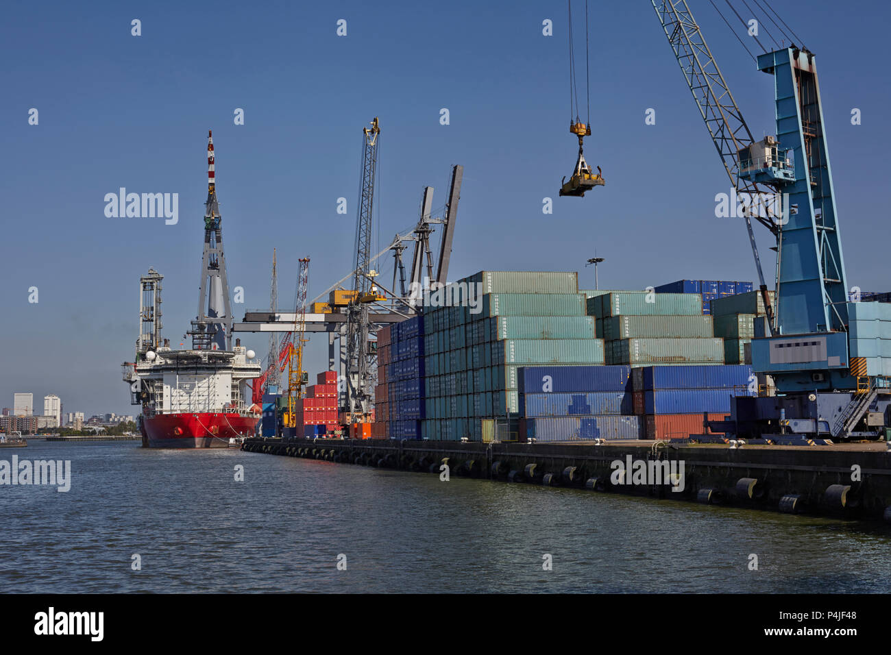 Large harbor cranes loading container ships in the port of Rotterdam ...