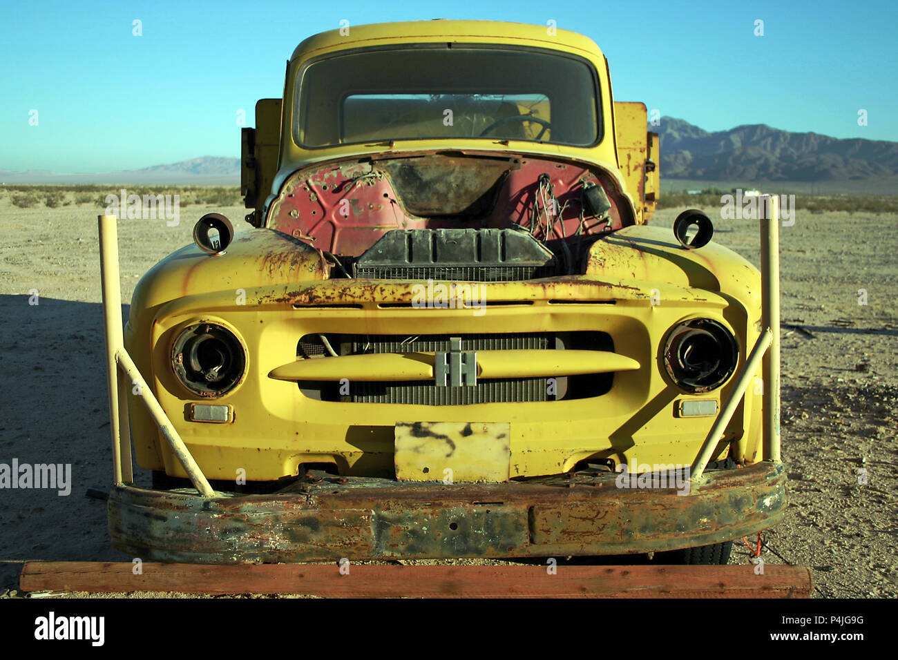 Old, abandoned, cannibalised, yellow 1954 International Harvester R-110 series pick up truck. Wonder Valley, near Joshua Tree, Mojave, California, USA Stock Photo