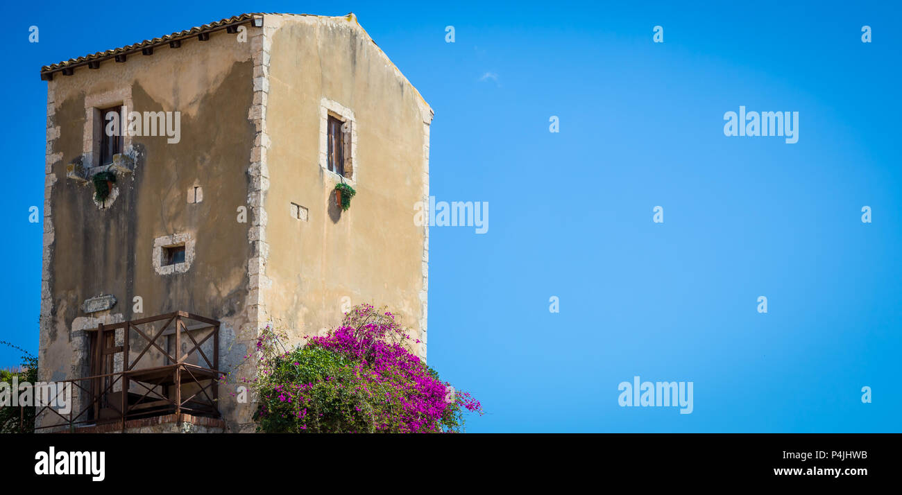 Traditional old Sicilian house during a sunny day with a wonderful blue sky background. Stock Photo