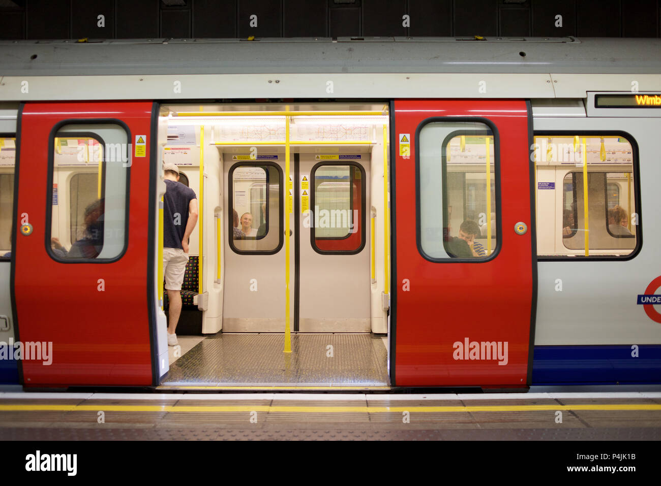 District Line train on the London Underground at Aldgate East station ...