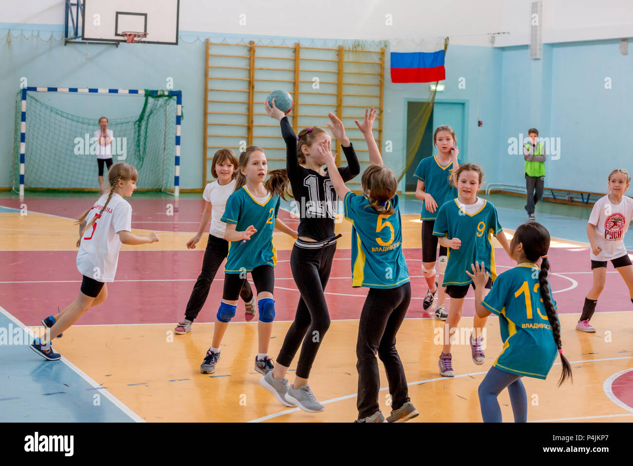 Russia, Vladivostok, 04/28/2018. Kids play handball indoor. Sports and
