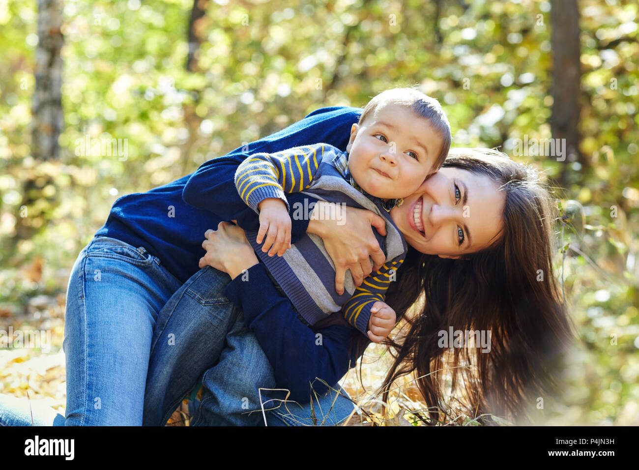 outdoor portrait of a young mother with her baby. Mom and son Stock
