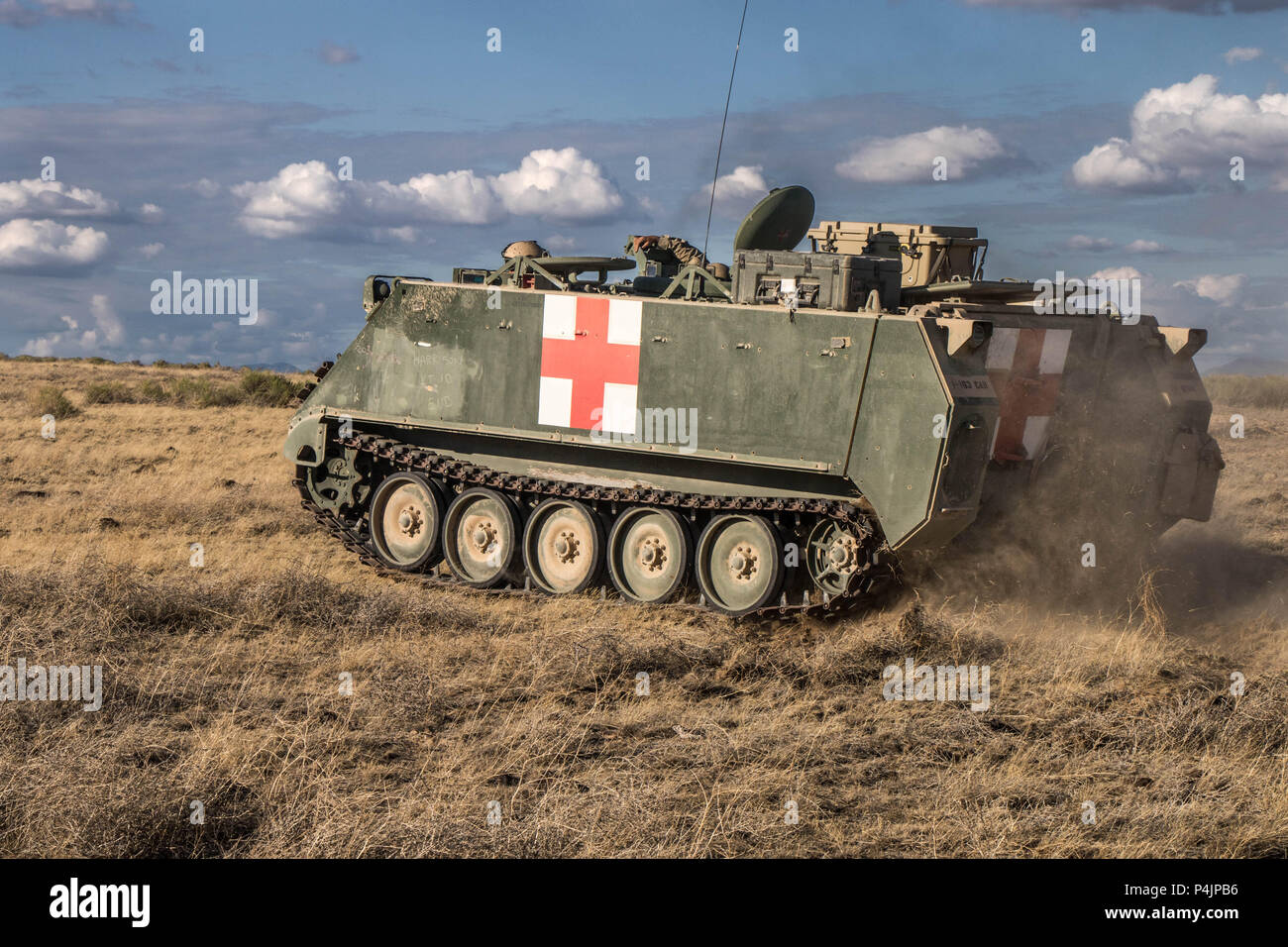 A medic M113 armored personnel carrier moves toward an objective during a simulated exercise at Orchard Training Center, Idaho, on June 19, 2018. The exercise allowed medics to perform simulated training of casualties within an armored vehicle. (U.S. Army photo by Spc. Michael Hunnisett) Stock Photo