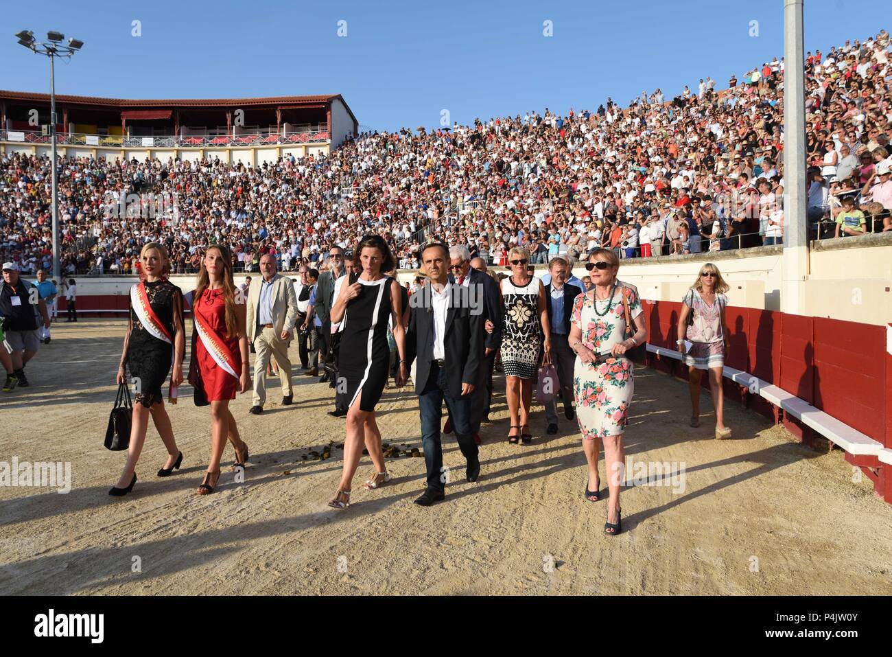 August 12, 2015 - Beziers, France: Beziers mayor Robert Menard (C) and his wife Emmanuelle Duverger march during a Virgin Mary procession from the town centre to the bullfighting arena. The town's new mayor, Robert Menard, has allowed the procession as well a large public mass to take part in the arena as part of his municipal programme to reinvigorate the town's Catholic traditions. Arrivee du maire de Beziers, Robert Menard, et sa femme Emmanuelle Duverger dans les arenes pour la messe en plein air qui precede l'ouverture de la corrida. Stock Photo