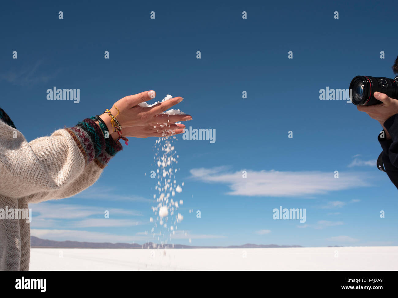 Photographer photographing a handful of salt in Salar de Uyuni (Uyuni salt flats), Bolivia Stock Photo