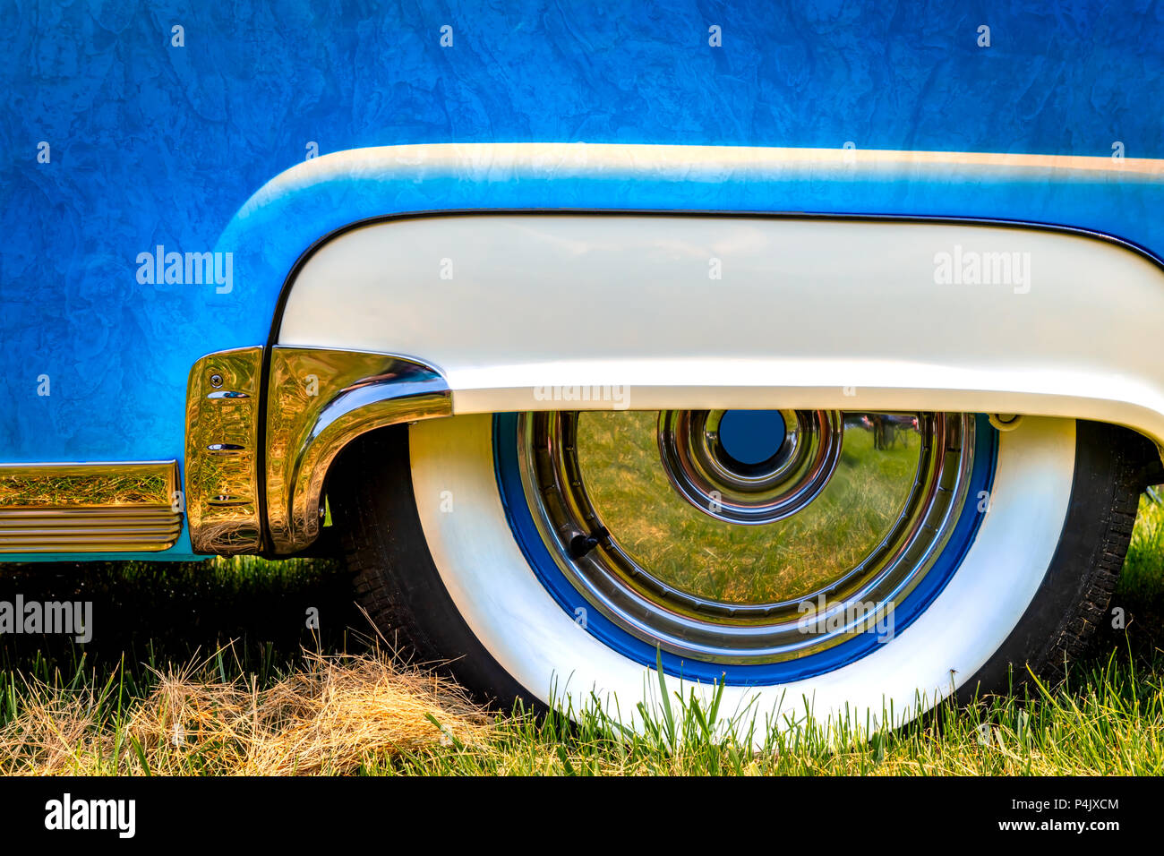 The rear wheel skirt and white wall tires of a fifties American classic car. Stock Photo