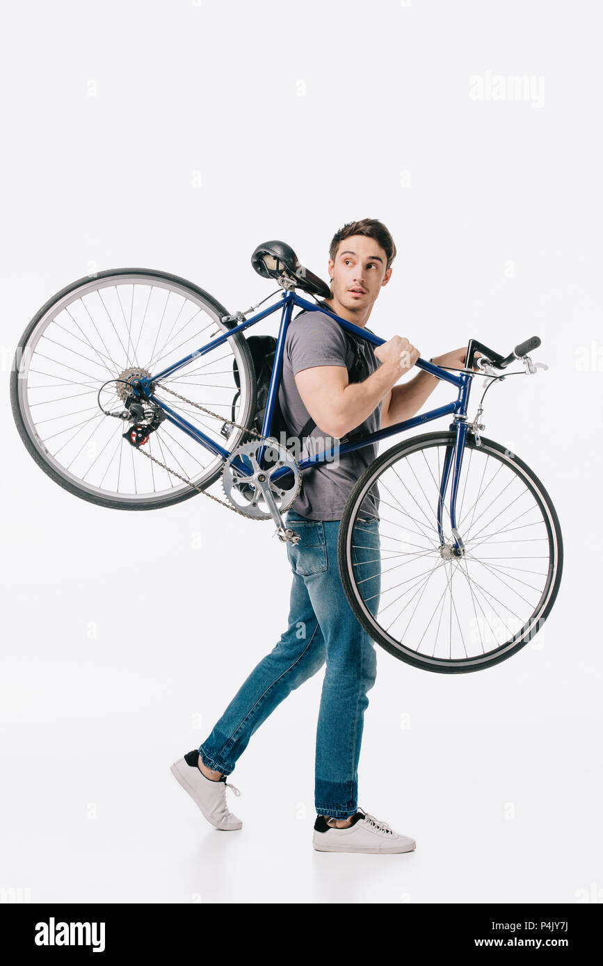 handsome student holding bicycle on shoulder isolated on white Stock Photo