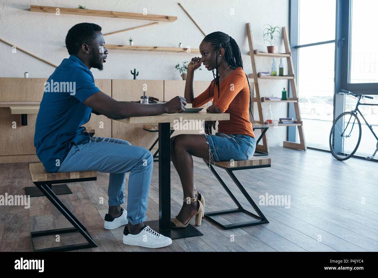 side view of african american couple having date in coffee shop Stock ...