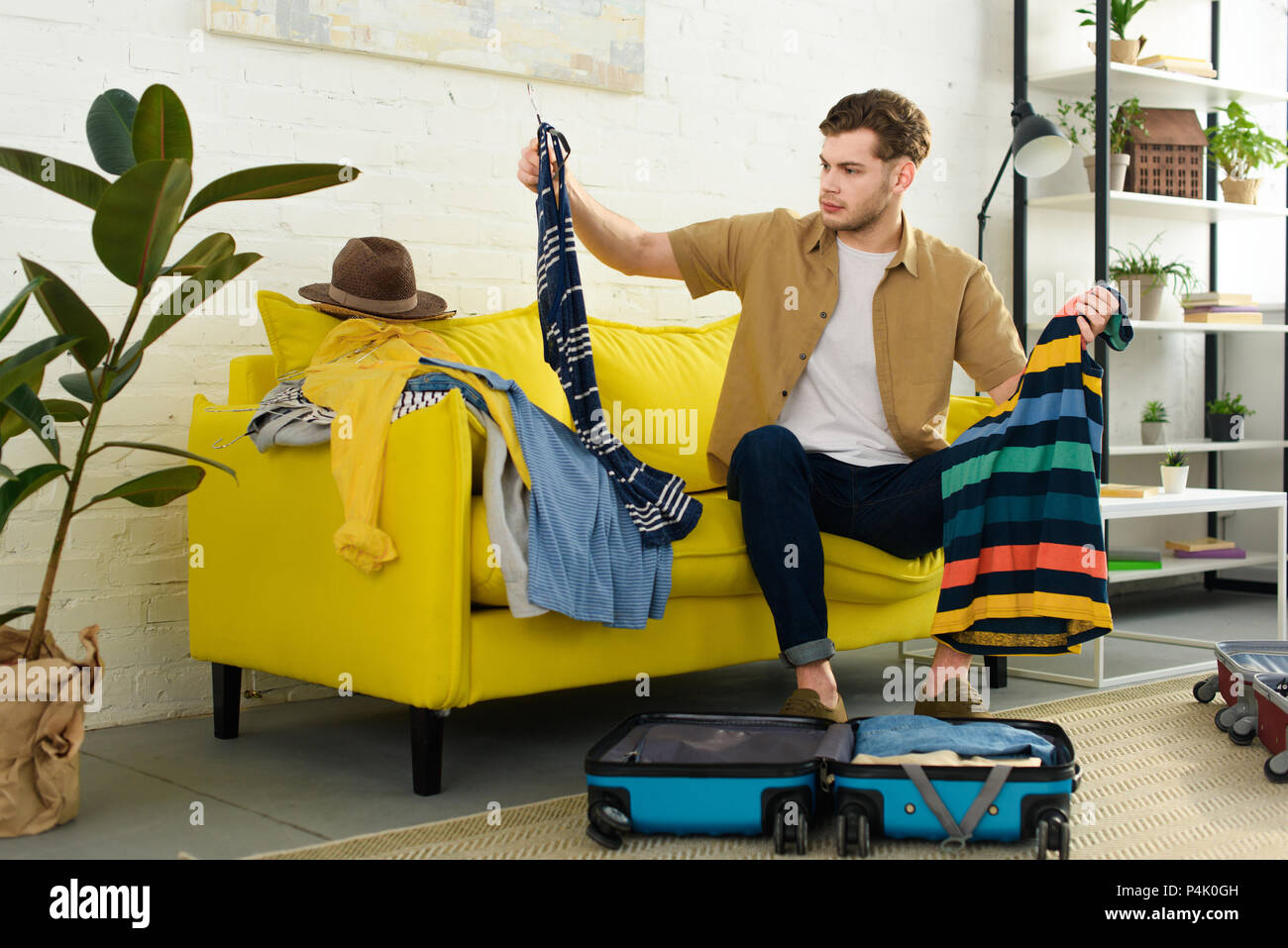 Man packing clothes hi-res stock photography and images - Alamy