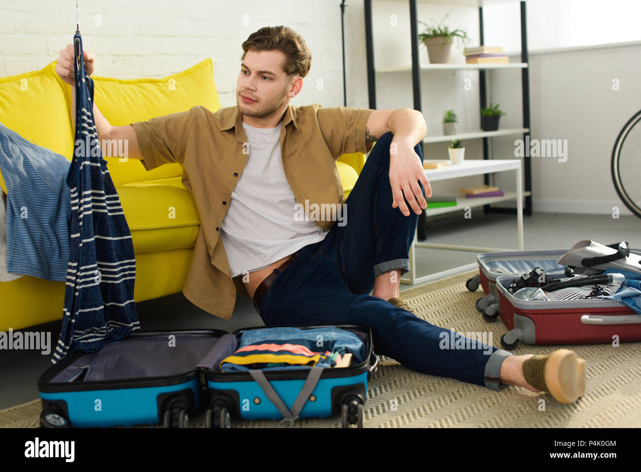 Man packing clothes hi-res stock photography and images - Alamy