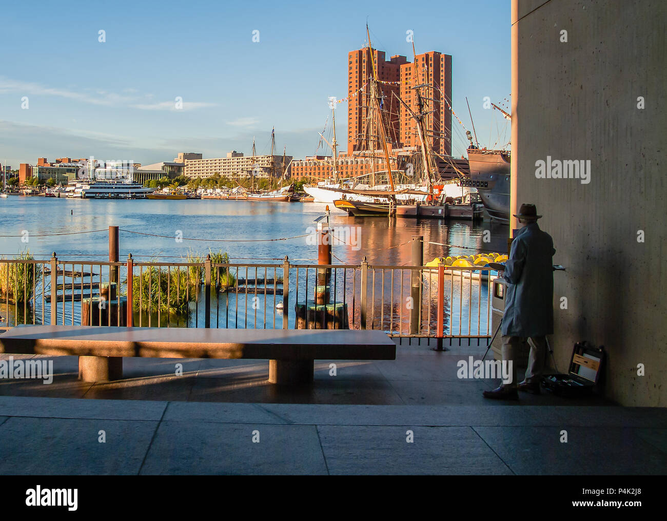 Man Painting Scenery Of Baltimore Inner Harbor Underneath World Trade Center Stock Photo