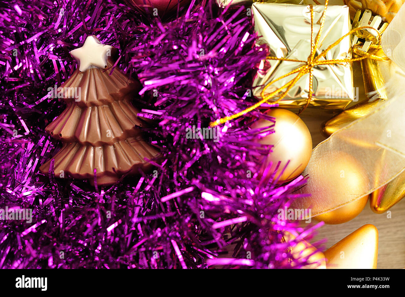 A chocolate christmas tree shape displayed with tinsel and golden