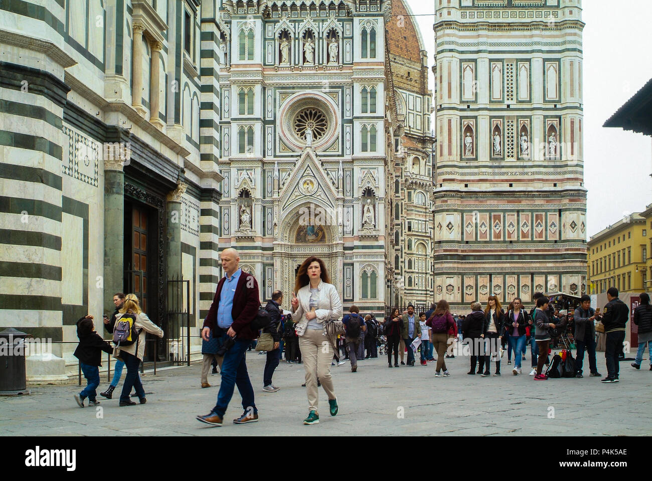 Florence, Italy - circa Spring 2018 - International tourists crowd visiting Santa Maria del Fiore, Florence Italy dome. Cloudy day Stock Photo