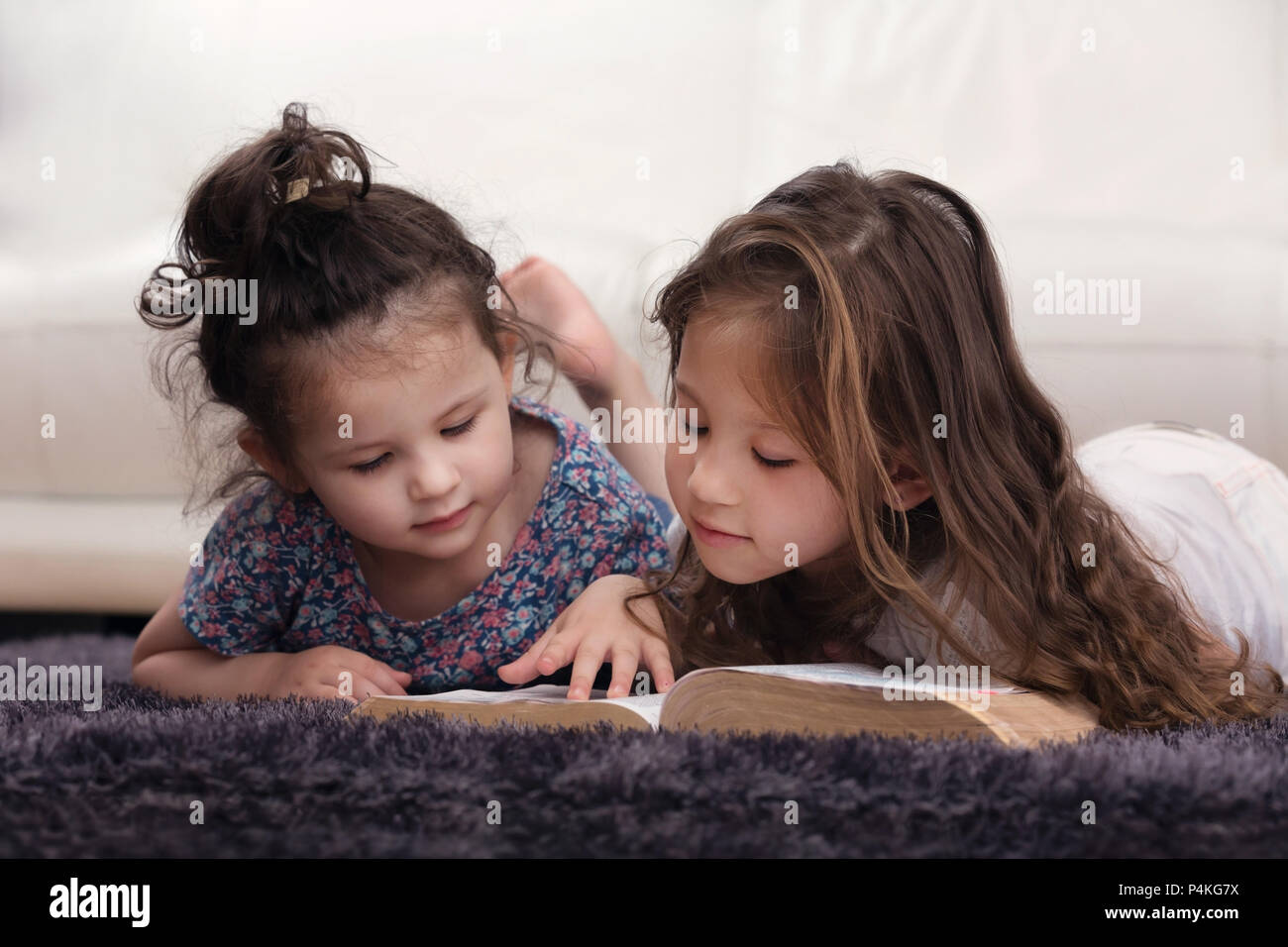 Young Siblings Learning the Word of God Together Stock Photo