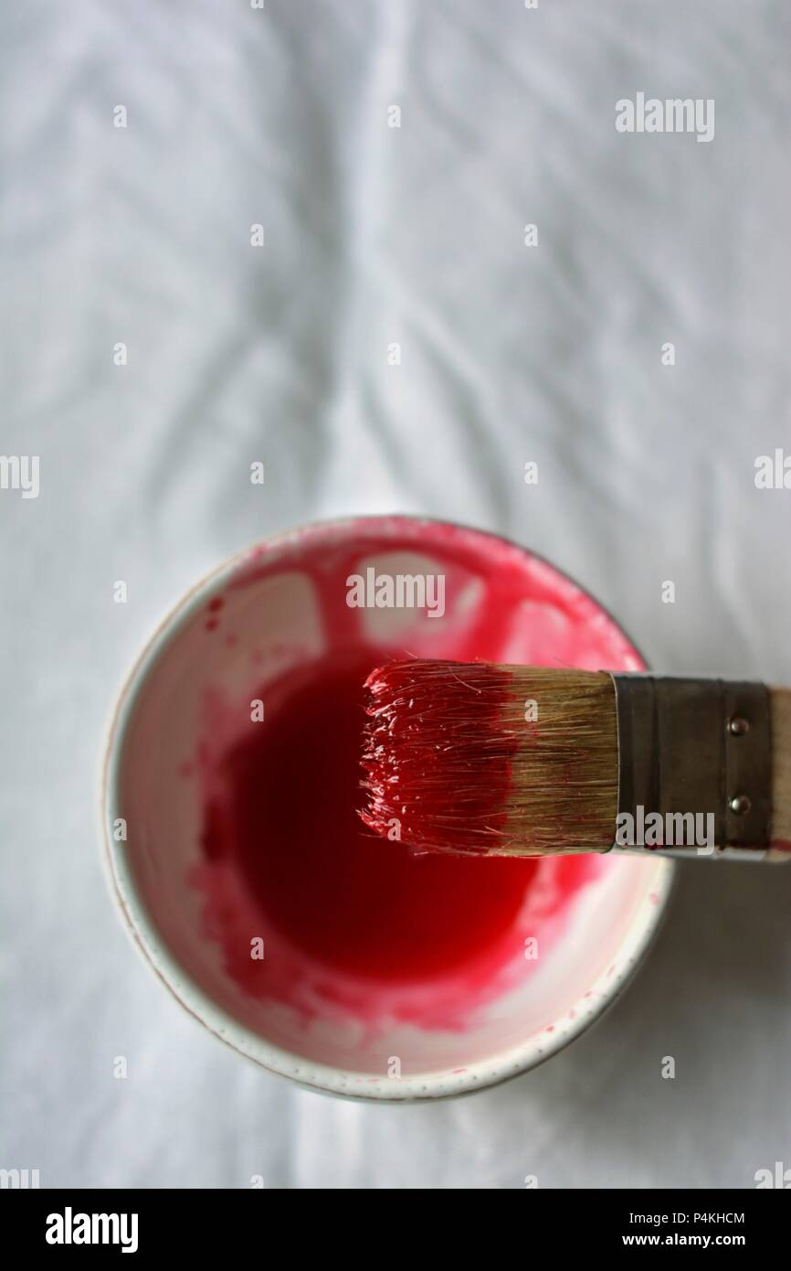 Rhubarb cordial in a small bowl with a brush Stock Photo